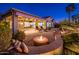 Spacious backyard patio with fire pit and seating area at 23206 N Del Monte Dr, Sun City West, AZ 85375