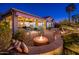 Spacious backyard patio with fire pit and seating area at 23206 N Del Monte Dr, Sun City West, AZ 85375