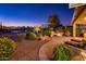 Landscaped backyard patio at dusk with fire pit and seating area at 23206 N Del Monte Dr, Sun City West, AZ 85375