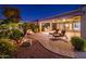 Evening view of a backyard patio with fire pit and seating at 23206 N Del Monte Dr, Sun City West, AZ 85375