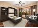 Bedroom with a built-in murphy bed, desk, and large window at 23206 N Del Monte Dr, Sun City West, AZ 85375