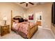 Comfortable bedroom with wood bed frame and ensuite bathroom access at 23206 N Del Monte Dr, Sun City West, AZ 85375