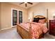 Charming bedroom with wood bed frame and French doors to patio at 23206 N Del Monte Dr, Sun City West, AZ 85375
