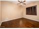 Simple bedroom with hardwood floors and a large window with shutters at 23206 N Del Monte Dr, Sun City West, AZ 85375