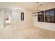Bright dining area with tile floors and a modern chandelier at 23206 N Del Monte Dr, Sun City West, AZ 85375