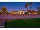 Back of house exterior view at dusk with golf course in the background at 23206 N Del Monte Dr, Sun City West, AZ 85375