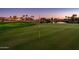Golf course putting green at dusk with flag and water feature at 23206 N Del Monte Dr, Sun City West, AZ 85375