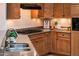 Modern kitchen with granite countertops and light wood cabinets at 23206 N Del Monte Dr, Sun City West, AZ 85375