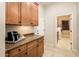Well-equipped kitchenette with granite countertop and wooden cabinets at 23206 N Del Monte Dr, Sun City West, AZ 85375