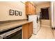 Bright laundry room with washer, dryer, cabinets, and granite countertops at 23206 N Del Monte Dr, Sun City West, AZ 85375