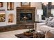 Cozy living room featuring a stone fireplace and built-in shelving at 23206 N Del Monte Dr, Sun City West, AZ 85375