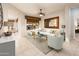 Bright living room featuring a comfortable sectional sofa and large window at 23206 N Del Monte Dr, Sun City West, AZ 85375