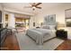 Main bedroom with hardwood floors and sliding glass doors leading to a patio at 23206 N Del Monte Dr, Sun City West, AZ 85375