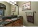 Bathroom with granite vanity and decorative artwork at 26398 W Cat Balue Dr, Buckeye, AZ 85396