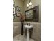 Elegant powder room with pedestal sink and decorative mirror at 26398 W Cat Balue Dr, Buckeye, AZ 85396