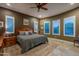 Bright bedroom with plush carpet, ceiling fan and plantation shutters at 26398 W Cat Balue Dr, Buckeye, AZ 85396
