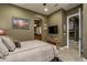 Spacious bedroom with ensuite access and a flat-screen TV at 26398 W Cat Balue Dr, Buckeye, AZ 85396