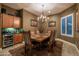 Formal dining room with a rustic wood table and chandelier at 26398 W Cat Balue Dr, Buckeye, AZ 85396