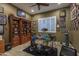 Game room with built-in shelving, drum set, and sports memorabilia at 26398 W Cat Balue Dr, Buckeye, AZ 85396