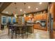 Spacious kitchen with an island, stainless steel appliances, and wood cabinets at 26398 W Cat Balue Dr, Buckeye, AZ 85396