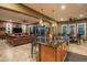 Open kitchen with an island, granite countertops, and views to living room at 26398 W Cat Balue Dr, Buckeye, AZ 85396