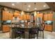 Island kitchen with granite countertops and wood cabinets at 26398 W Cat Balue Dr, Buckeye, AZ 85396