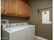 Bright laundry room, featuring washer, dryer, and ample cabinetry at 26398 W Cat Balue Dr, Buckeye, AZ 85396