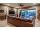Spacious living room with leather sectional sofa and sliding doors to patio at 26398 W Cat Balue Dr, Buckeye, AZ 85396
