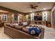 Spacious living room featuring a large sectional sofa and built-in entertainment center at 26398 W Cat Balue Dr, Buckeye, AZ 85396