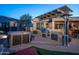 Hot tub and outdoor kitchen area with pergola and bar seating at 26398 W Cat Balue Dr, Buckeye, AZ 85396