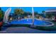Inviting kidney-shaped pool with artificial turf and shade umbrellas at 26398 W Cat Balue Dr, Buckeye, AZ 85396