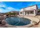 Inviting backyard oasis featuring a sparkling pool and relaxing waterfall feature at 3109 E Denim Trl, San Tan Valley, AZ 85143