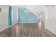 Bright dining room with light wood floors and a teal accent wall at 3109 E Denim Trl, San Tan Valley, AZ 85143