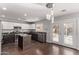 Modern kitchen with dark cabinets, granite counters and island at 3109 E Denim Trl, San Tan Valley, AZ 85143
