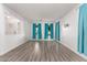 Bright living room with hardwood floors and teal curtains at 3109 E Denim Trl, San Tan Valley, AZ 85143