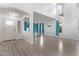 Spacious living room with hardwood floors and teal curtains at 3109 E Denim Trl, San Tan Valley, AZ 85143