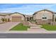 Beautiful home exterior featuring stone accents and a lush green lawn at 31509 N 55Th Way, Cave Creek, AZ 85331