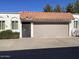 Front view of a Spanish-style home with a two-car garage and a terracotta tile roof at 3401 N 37Th St # 14, Phoenix, AZ 85018