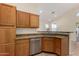 Kitchen boasts granite countertops and wood cabinets at 3635 W Firehawk Dr, Glendale, AZ 85308