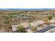 A lovely exterior aerial view of a home with a manicured lawn, landscaping, and mountain views at 41512 N Tangle Ridge Ct, Anthem, AZ 85086