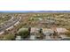 Scenic aerial view of a desert home close to a golf course and lake, framed by the majestic mountains at 41512 N Tangle Ridge Ct, Anthem, AZ 85086