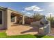Covered patio, built-in grill, fire pit, and artificial turf at 41512 N Tangle Ridge Ct, Anthem, AZ 85086