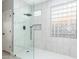 Modern bathroom with glass shower, stylish tile, and a large window at 41512 N Tangle Ridge Ct, Anthem, AZ 85086