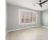 Spacious bedroom with ceiling fan and large window at 41512 N Tangle Ridge Ct, Anthem, AZ 85086