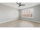 Bright bedroom with ceiling fan and plantation shutters at 41512 N Tangle Ridge Ct, Anthem, AZ 85086