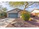 House exterior with a gray garage door and desert landscaping at 41512 N Tangle Ridge Ct, Anthem, AZ 85086