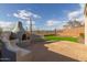 Stone fire pit with seating and desert views at 41512 N Tangle Ridge Ct, Anthem, AZ 85086