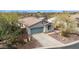 This home boasts desert landscaping, an attached two-car garage, and is situated among mature desert vegetation at 41512 N Tangle Ridge Ct, Anthem, AZ 85086