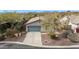 This home boasts desert landscaping, an attached two-car garage, and is situated among mature desert vegetation at 41512 N Tangle Ridge Ct, Anthem, AZ 85086