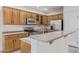 Modern kitchen with wood cabinets and granite countertops at 41512 N Tangle Ridge Ct, Anthem, AZ 85086